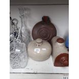 Three glass decanters and three bed warmers