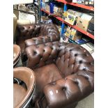 A pair of chesterfield brown leather tub chairs