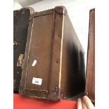 A vintage travel trunk and two vintage cases