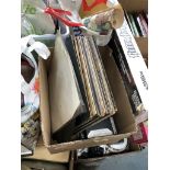 A box of vinyl lps and cassettes