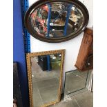 A tall mirror and an oval mirror