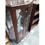 A bow front glazed display cabinet