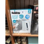 A boxed Beldray handheld garment steamer.