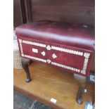 An upholstered sewing box on cabriole legs