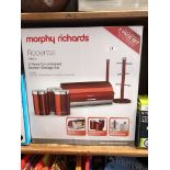 A boxed Morphy Richards Accents red 6 piece co-ordinated kitchen storage set.