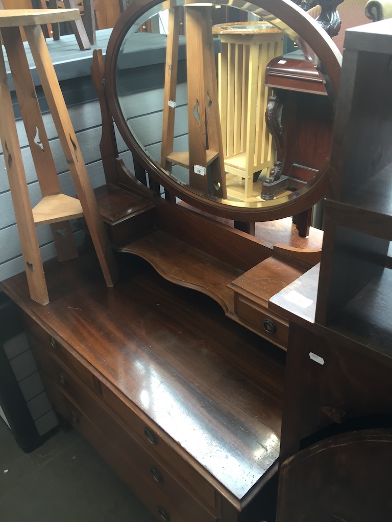 A mahogany dressing table with oval swing mirror