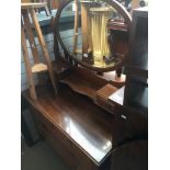 A mahogany dressing table with oval swing mirror
