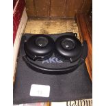 A pair of AKG C50 BT by Harman headphones in soft case.