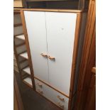 A pine wardrobe with white doors together with a matching shelving unit