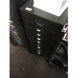 A vintage green metal multi drawer filing cabinet