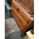 An oak chest of drawers with aesthetic brass handles