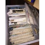 A box of postcards with cigarette cards.