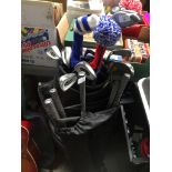 A golf bag containing a set of SL206 golf clubs and another bag with extra clubs