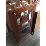 A mahogany mirrored cabinet