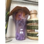 Purple glass vase and a hat
