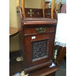 A mahogany coal cabinet converted to bedside