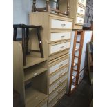 Two matching chests of drawers, a matching tall shelving unit and a matching bedside cabinet