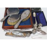 A mixed lot of hallmarked silver comprising brushes, a hand mirror, pepper pots etc.