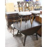 An Ercol dining room suite consisting drop leaf table, four fleur de lys back chairs and sideboard.