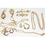 A mixed lot of gold and yellow metal comprising a hallmarked 9ct gold brooch, a chain marked '9c', a