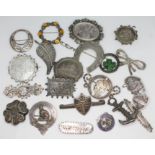 A group of 21 Victorian and later brooches comprising eight hallmarked silver, two marked '