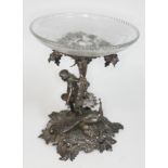 An Edwardian silver plated centre piece formed as a girl picking grapes with peacock below vines and