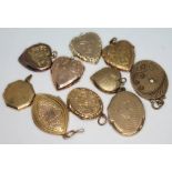 A group of 10 yellow metal lockets.