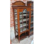 A good quality Edwardian inlaid mahogany display cabinet with domed back having swags and bows