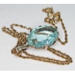 An Art Deco marquis mixed cut aquamarine pendant set in open work white metal unmarked and hung on