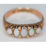 A hallmarked 9ct gold five stone precious opal ring, gross wt. 2.72g, size P.