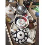 A wooden crate of plates, tea pots, etc.