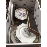 A box of misc pottery plates, a hot tray, placemats, etc.