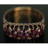 A hallmarked 22ct gold and yellow metal ring set with purple paste, gross wt. 3.64g, size Q.