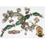 A mixed lot comprising a hallmarked silver charm bracelet, a modernist white metal bracelet set with