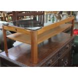 A retro teak coffee table by Myer with smoked glass top, length 112cm.