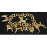 A hallmarked 9ct charm bracelet with five poodle charms and a thistle charm, length approx. 17.