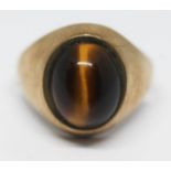 A hallmarked 9ct gold signet ring set with a quartz tiger's eye cabochon, gross wt. 4.94g, size P.