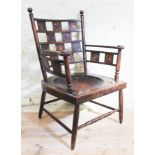 A late Victorian Arts & Crafts armchair with embossed leather panels depicting various animals,