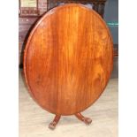 A 19th century mahogany loo table of oval form with turned pedestal base with four legs having