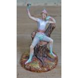 A rare and unusual Royal Worcester porcelain figure depicting a jester or pixie holding a flower and