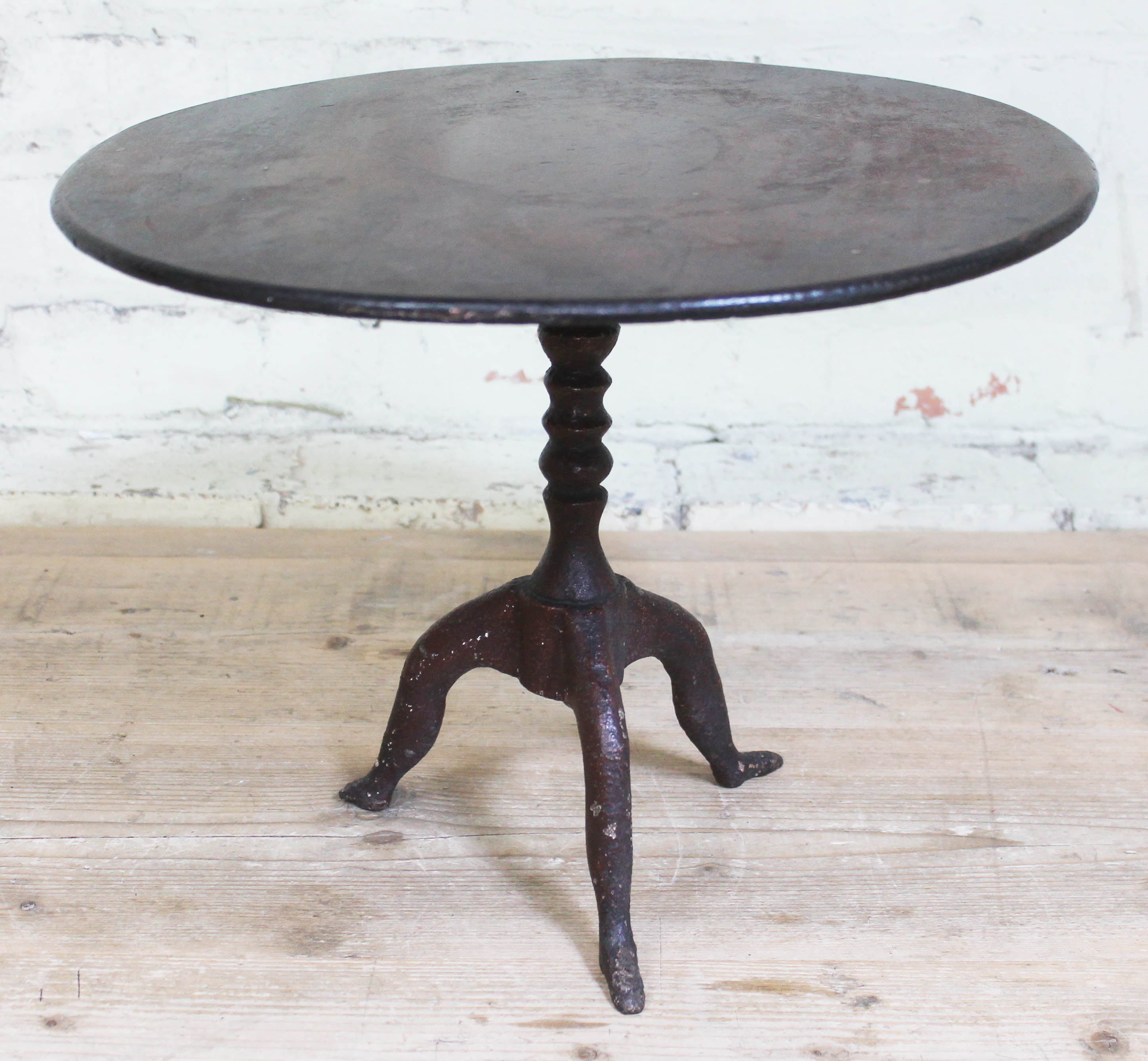 A Georgian "Isle of Man" miniature tripod table with cast iron base formed as three legs and round