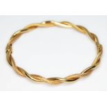 A twist bangle, marked '375', diam. 5.8cm, wt. 4.88g. Condition - good, no damage/repair, minor