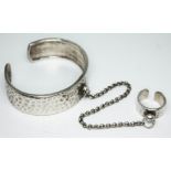 A vintage hammered pewter bangle and ring with linked chain by Scooter Paris, numbered '52' and