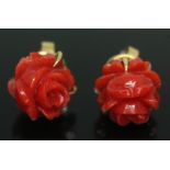 A pair of carved coral ear studs, marked '18K', length 2mm, gross wt. 4.91g, with box stamped 'Fat