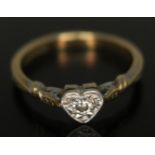 A single stone diamond ring, the diamond approx. 0.08 carats and set within a heart shaped