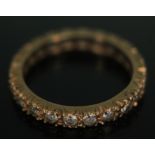 An eternity ring set with colourless spinel, marked '9ct & sil', gross wt. 2.14g, size M.