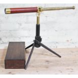 A 19th century two drawer brass and wooden bound travel telescope, fitted in box with tripod and sun