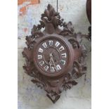 A 19th century Black Forest wall clock with enamel Roman numerals, length 65cm.