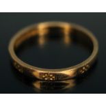 A hallmarked 22ct gold wedding band with outer engraved designs, wt. 2.28g, size N.