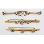 A group of three bar brooches comprising one set with a central rock crystal quartz and split
